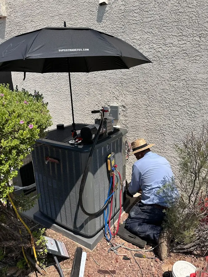HVAC technician performing outdoor AC maintenance in Kingston